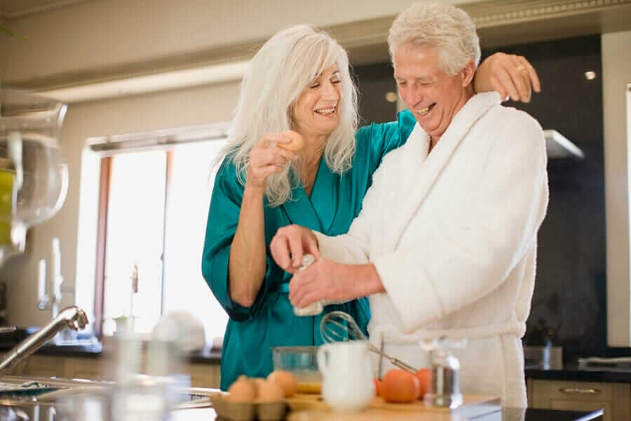 image shows as smiling older couple