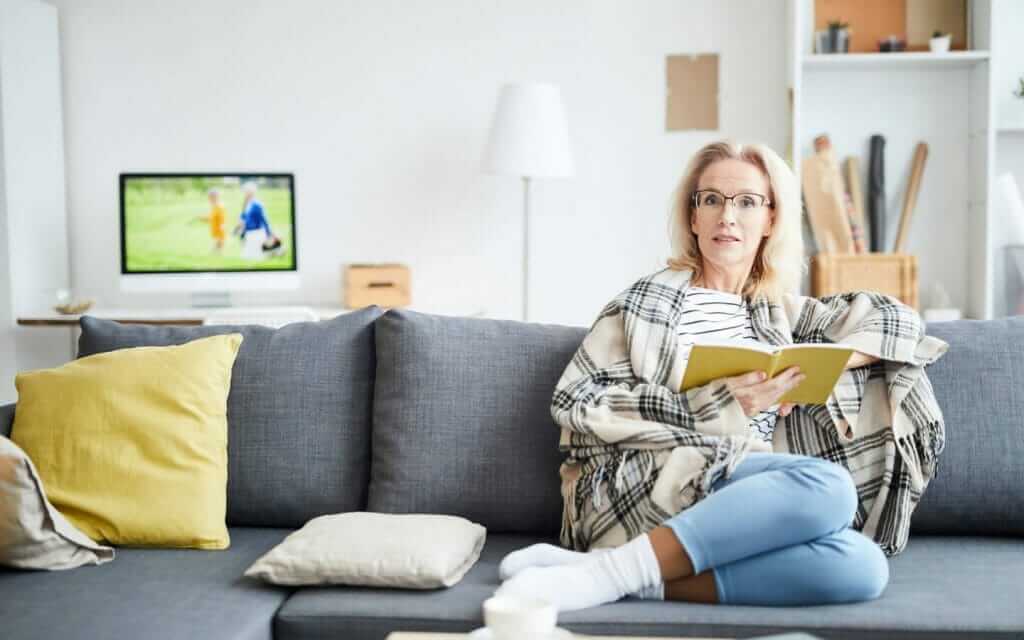 Female on couch reading a book