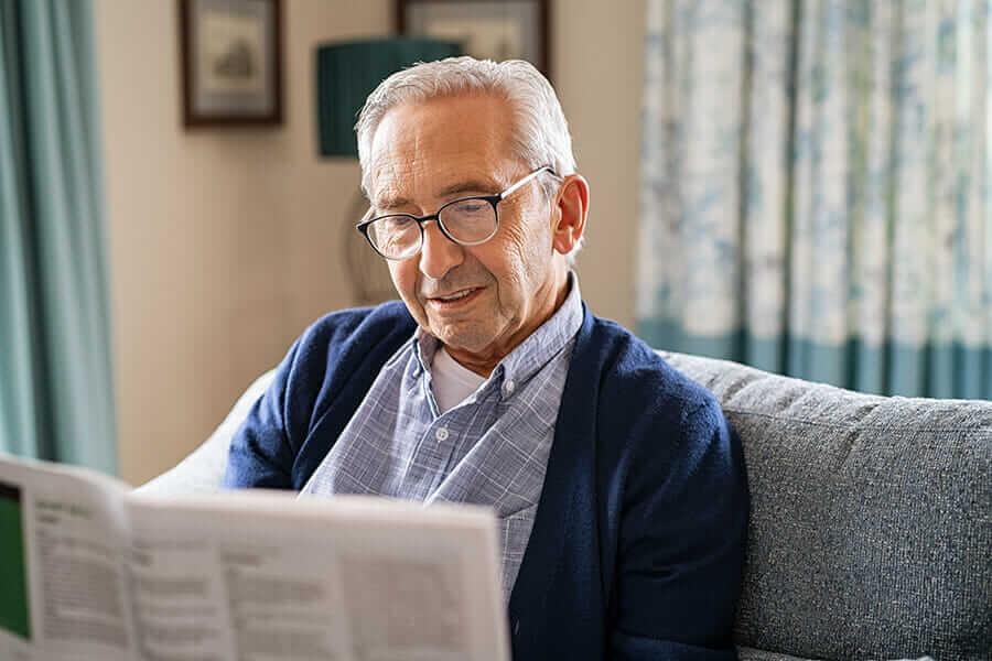 Older man reading paper